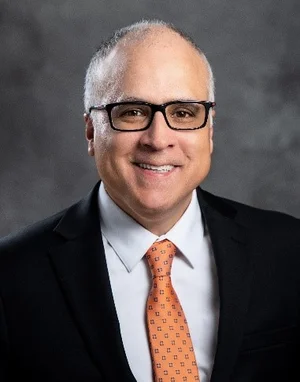 Hector Sosa headshot photo, in a suit and tie.