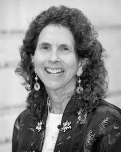 Woman smiling for a photo in black and white.