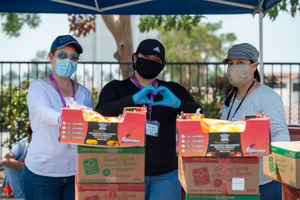 3 workers handing out food.