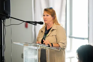 a woman speaking at the podium at the event