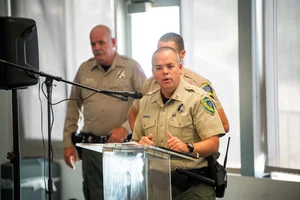 officers speaking at a podium