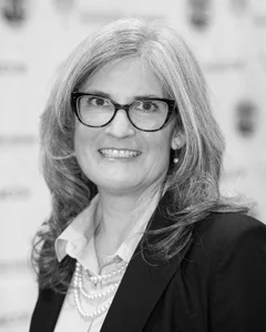 Woman smiling for a photo in black and white.