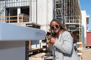 Supervisor Mitchell pointing to graffiti at a construction site