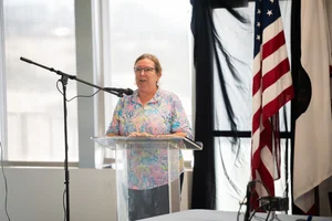 a woman speaking at a podium