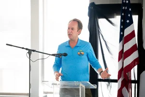 a man speaking at the podium at the event