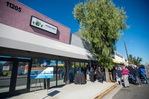 a large group of people standing outside of a building.