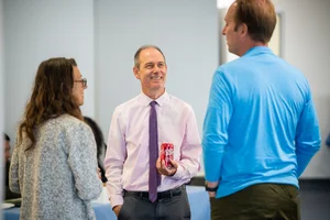 3 people speaking to each other at event
