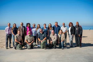 a group of people in front of the beach