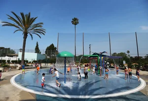 kids playing at the splashpad in Alondra park.