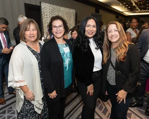 4 women posing for a photo.