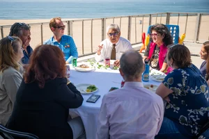 a group of people sitting at a table outside