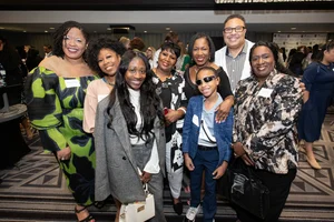 A group photo of 8 people smiling.