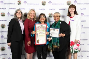 Supervisor Barger smiling for a photo with 4 other woman while they hold up a few rewards.