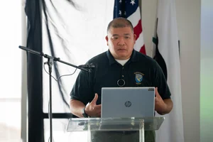a man speaking at the podium at the event