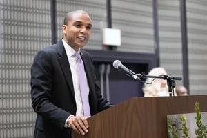 a man speaking at a podium.