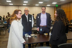 Supervisor Horvath speaking to 3 other adults at an event.