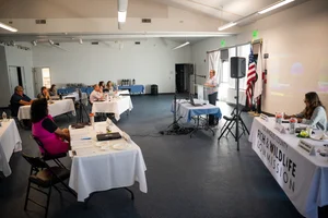 a group of people sitting at tables at an event.