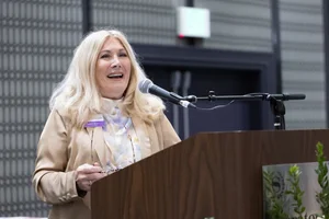 a woman speaking at a podium