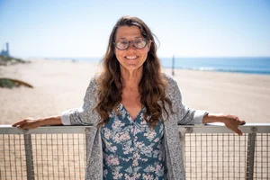 a woman standing in front of the beach