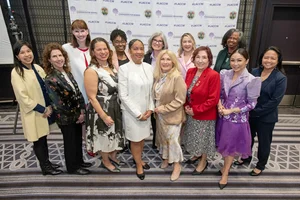 A group photo of 10+ women.