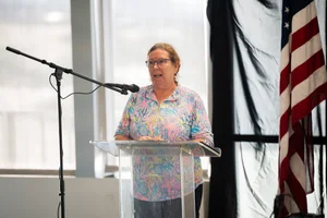 a woman speaking at a podium