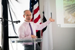 a man speaking at the podium at the event
