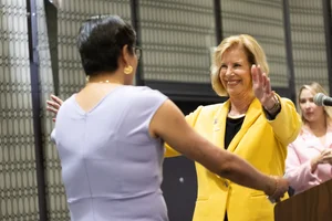 Supervisor Hahn hugging someone at a podium.