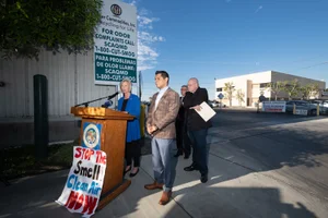 Supervisor Hahn speaking at a podium at the Baker Commodities AQMD Presser
