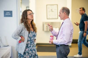 2 people speaking to each other at event