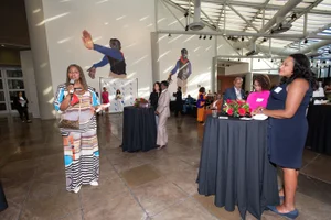 Supervisor Mitchell speaking at a celebration into a microphone