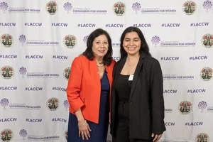 Supervisor Holis smiling for a photo with another woman.