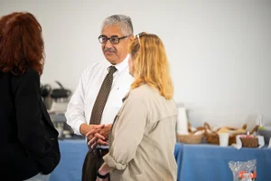 3 people speaking to each other at event