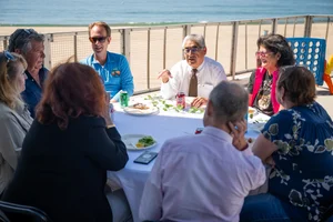 a group of people sitting at a table outside