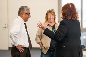 3 people speaking to each other at event