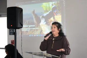 A woman speaking at the podium at an event.