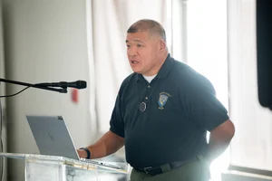 a man speaking at the podium at the event