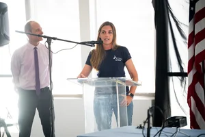 a woman speaking at the podium at the event