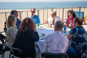 a group of people sitting at a table outside