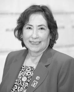 Woman smiling for a photo in black and white.