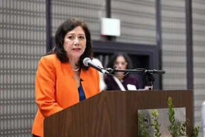 Supervisor Holis speaking at a podium.