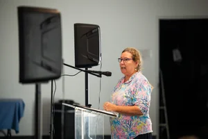 a woman speaking at a podium