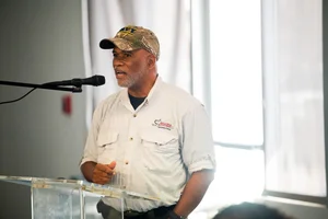 a man speaking at the podium at the event