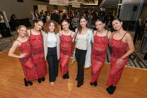7 women posing for a photo together.