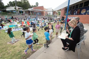 Supervisor Hahn writing in a book to kids at the Dapplegray Elementary School Book Fair