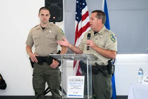 2 officers speaking at the podium