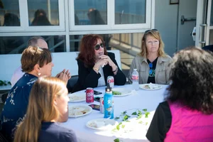 a group of people sitting at a table outside
