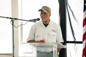 a man speaking at the podium at the event