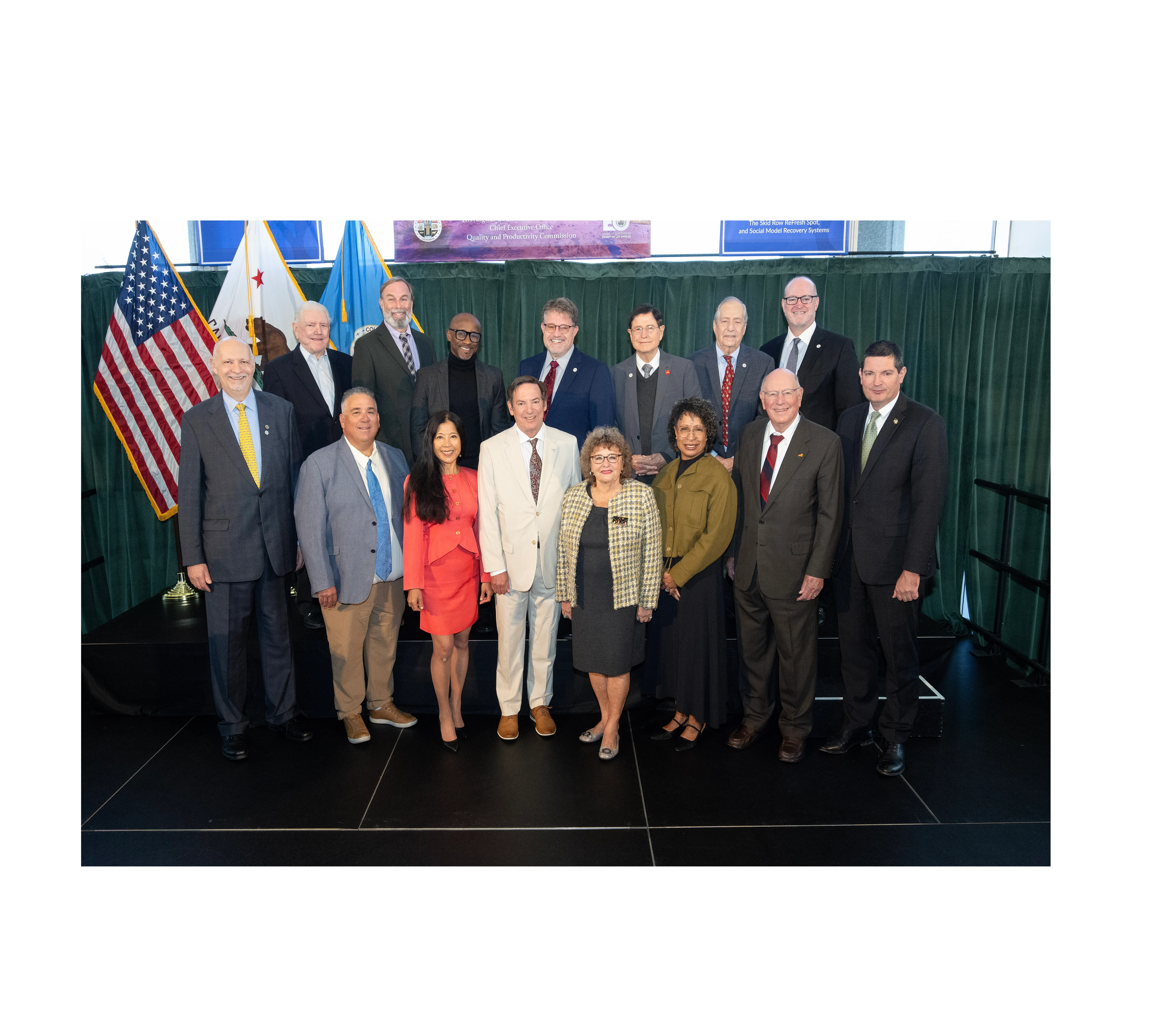 Group photo of the QPC Commissioners posing on stage.