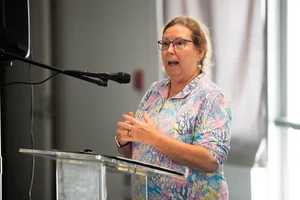 a woman speaking at a podium