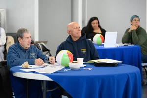 people sitting at tables at an event.